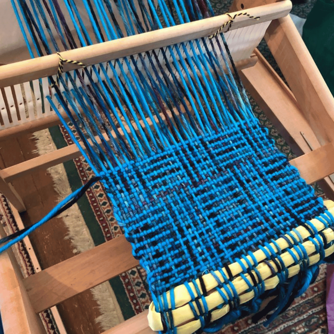 Rigid Heddle Loom with blue and black yarn weaving